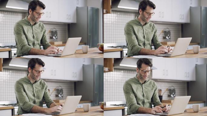 一个男子在家里做文书工作时使用笔记本电脑