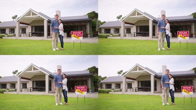 一对年轻夫妇站在他们新买的房子前