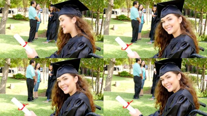 坐在轮椅上的大学毕业生自豪地拿着毕业证书
