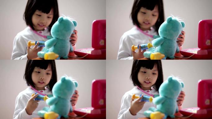 中国幼儿与泰迪熊玩假装医生的特写镜头