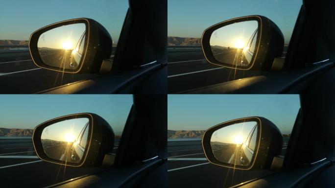 后视镜中的日落驾驶开车方向盘定位行驶导航