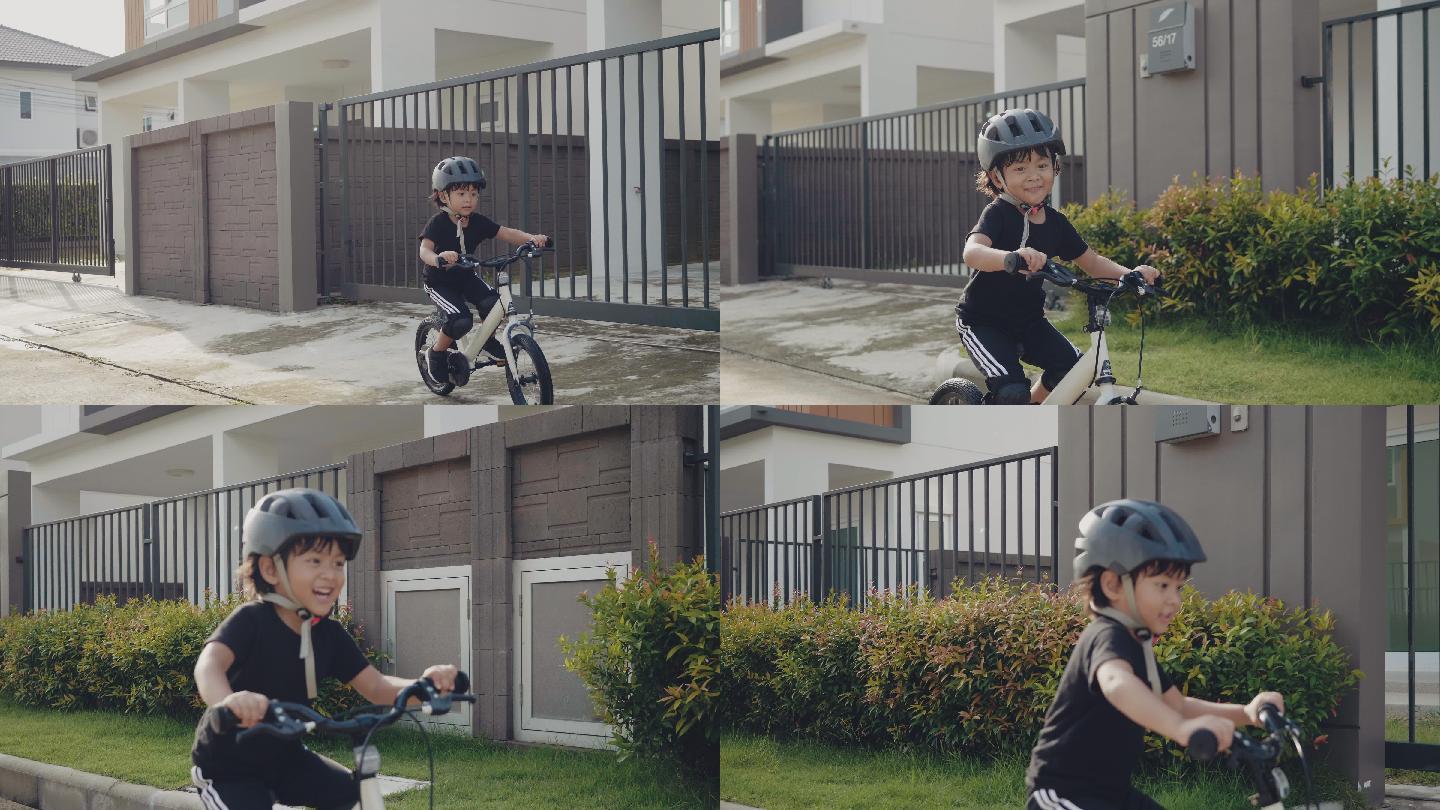 小男孩骑自行车很开心。
