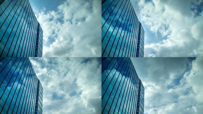 云层移动的天空反射在办公楼的玻璃窗上