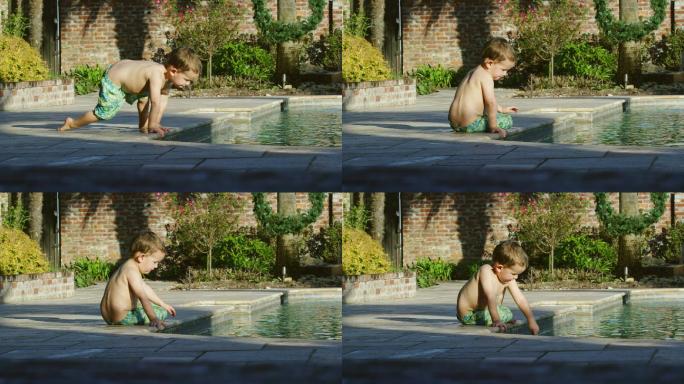 在泳池边玩耍的小男孩