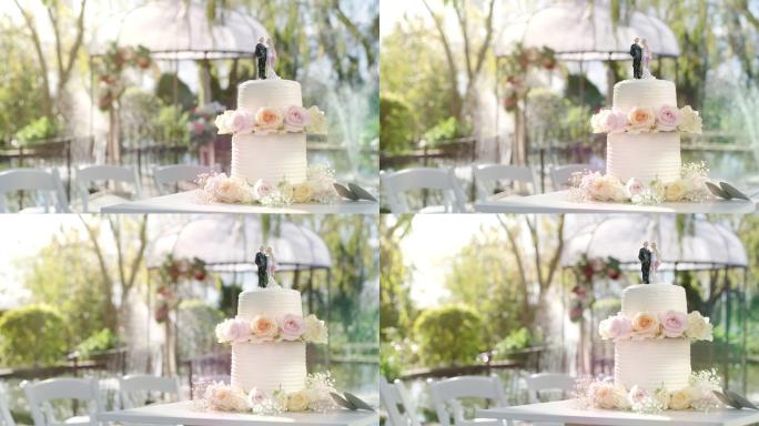 白天婚礼前用玫瑰装饰的婚礼蛋糕