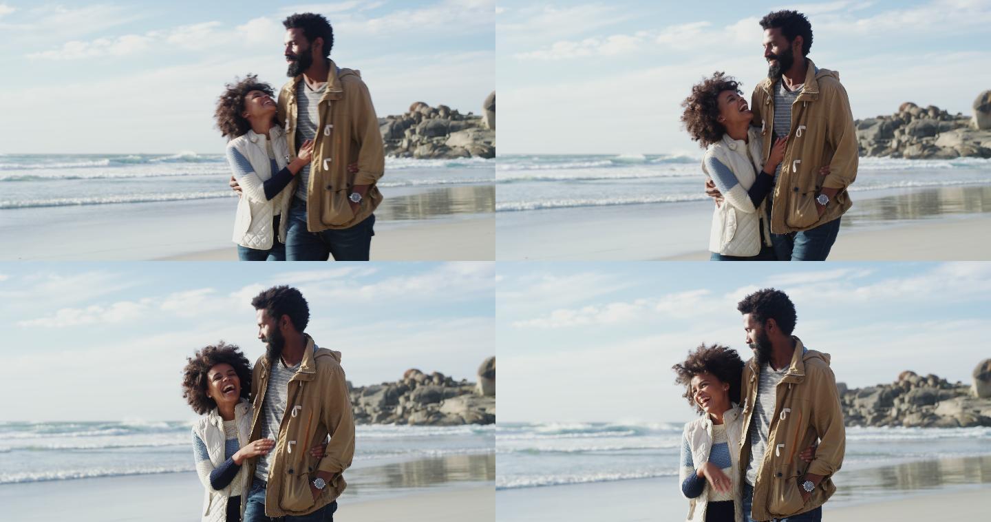 一对幸福的年轻夫妇在海滩上散步
