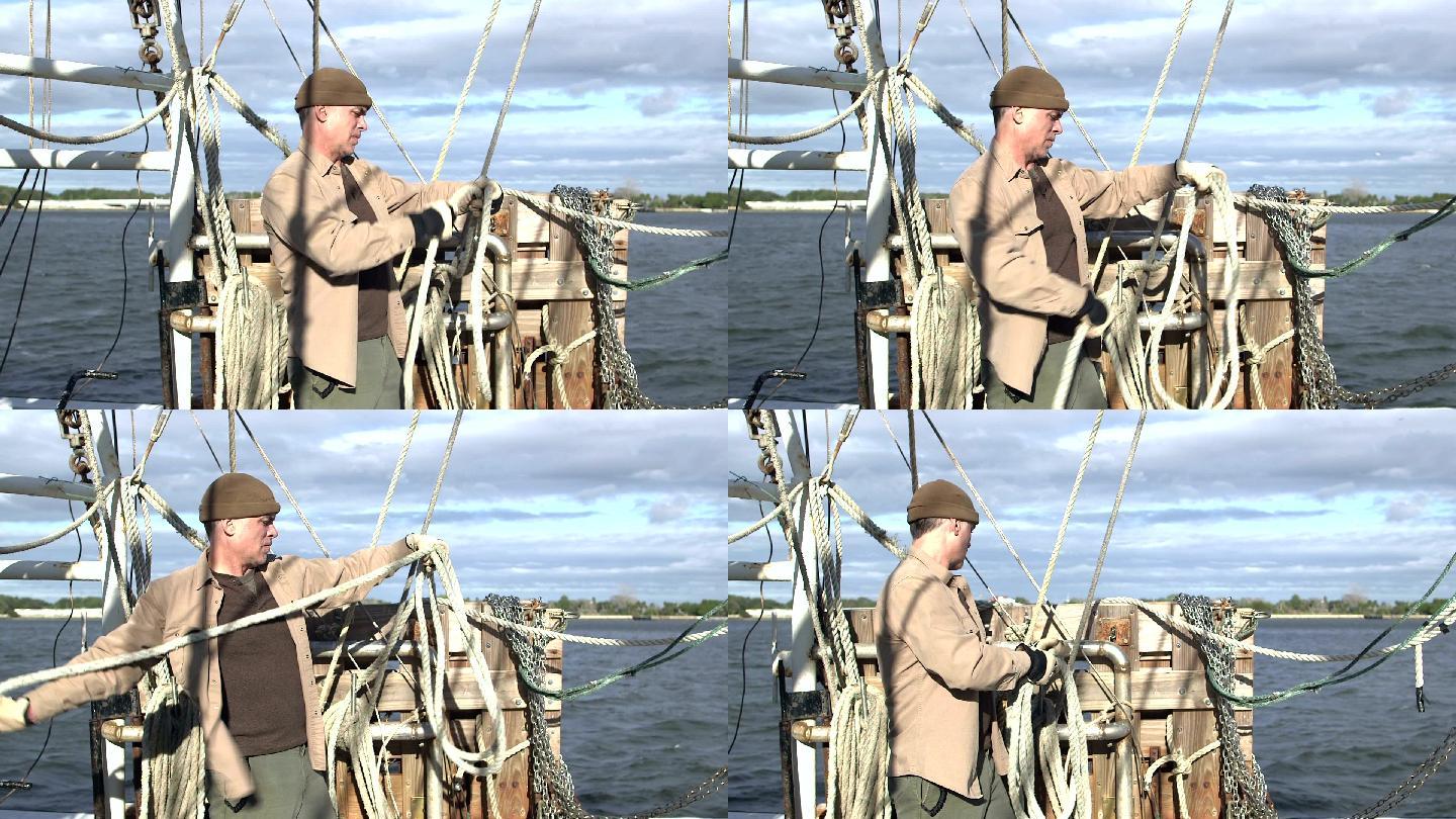 在商业渔船上缠绕绳索的男子