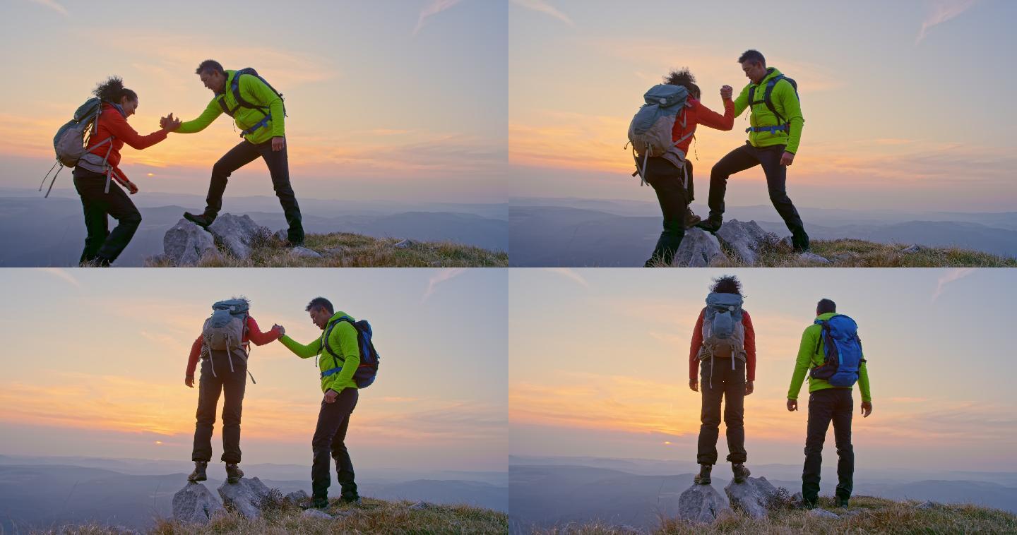 男女徒步旅行者日落时站在山顶