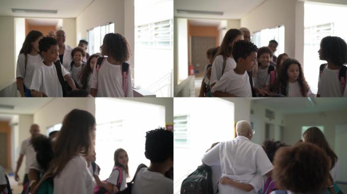 小学生走在学校走廊里拥抱老师