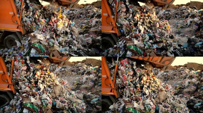 垃圾车在垃圾填埋场倾倒垃圾。