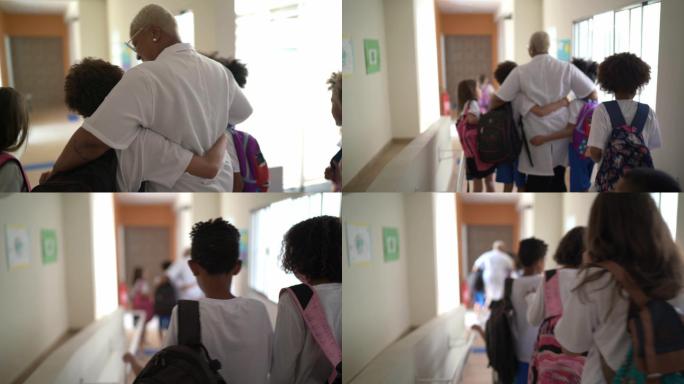 小学生们走在学校走廊里
