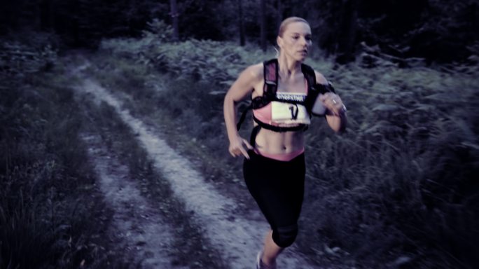 女子在日落时跑小道马拉松