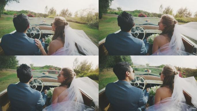 快乐的新娘和新郎一起在乡下开车