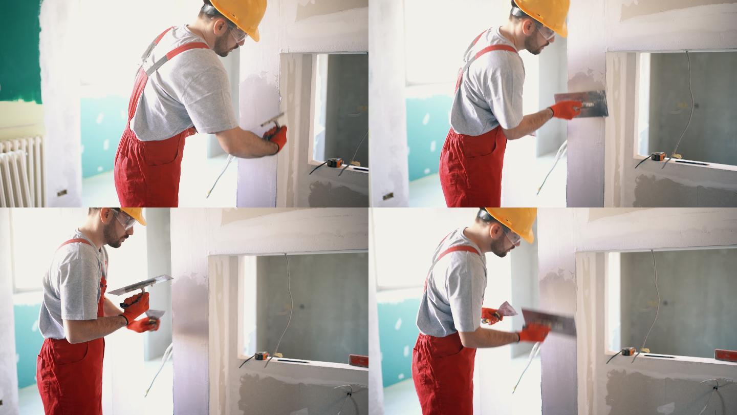 正在粉刷墙壁的建筑工人。