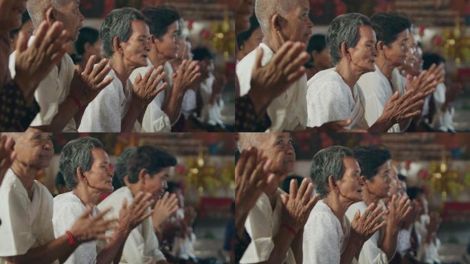 柬埔寨农村寺庙里念经祈祷的老人