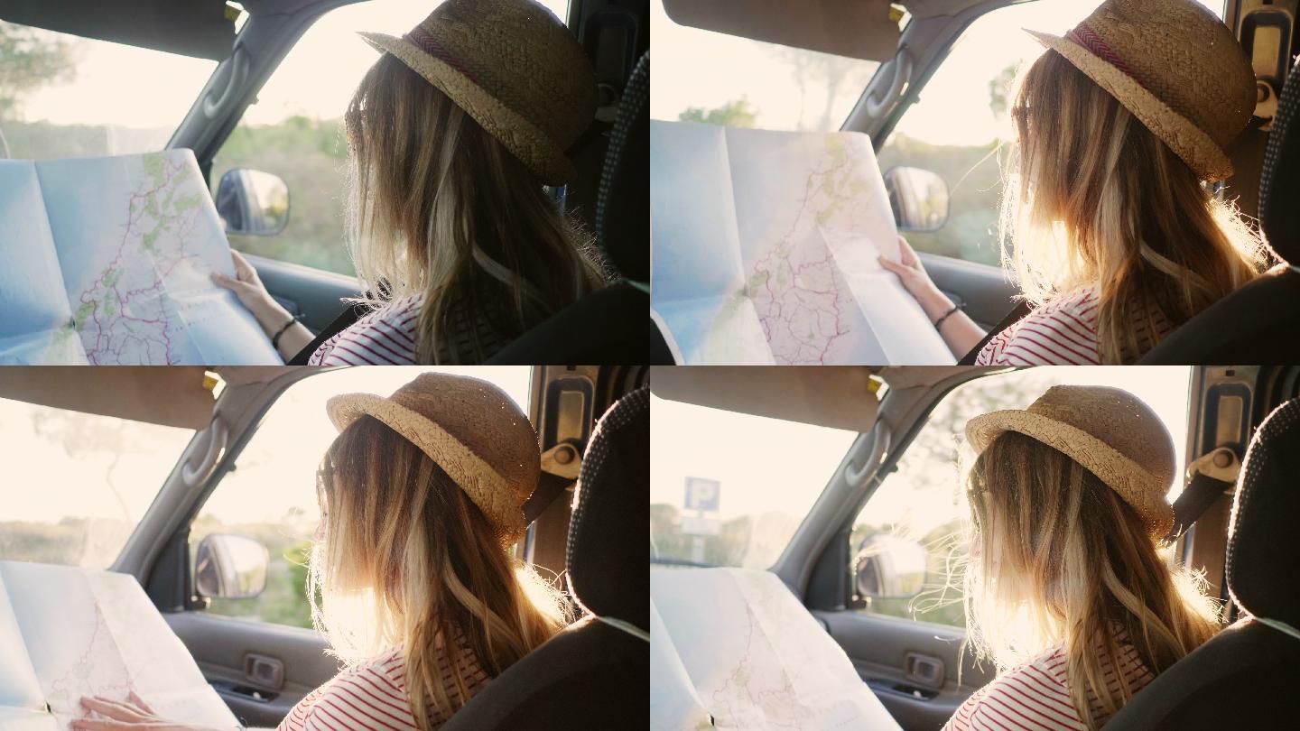 坐在车里看路线图的女人