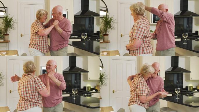 一对老年夫妇在家厨房跳舞