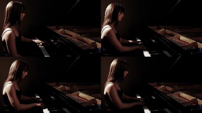 弹钢琴的年轻女子。