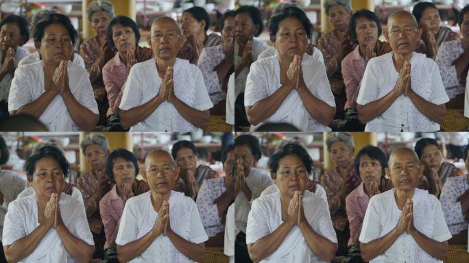 柬埔寨农村寺庙里念经祈祷的老人