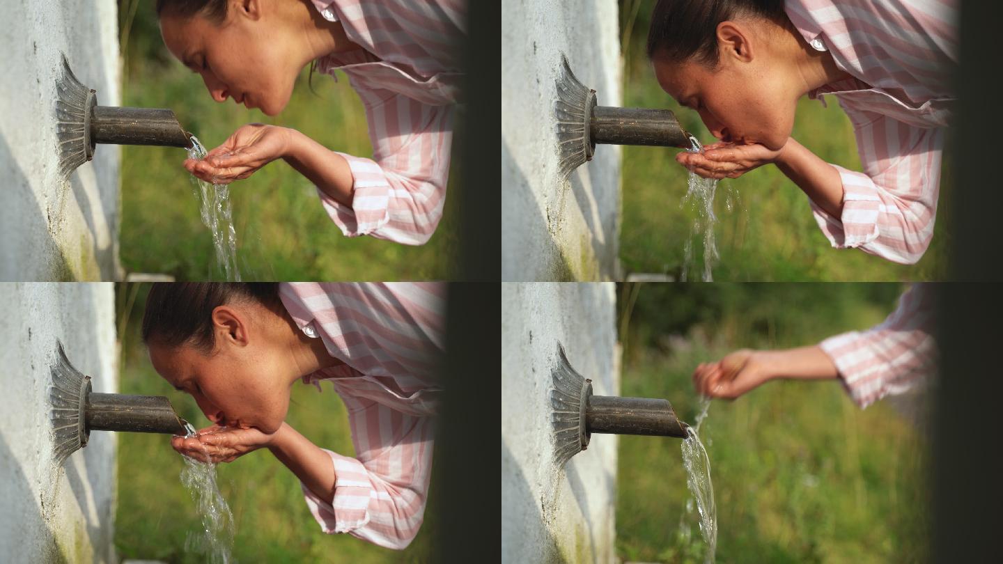 一个年轻女子在享受天然泉水的新鲜山水