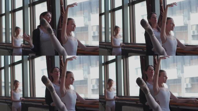芭蕾舞老师帮助小芭蕾舞演员。