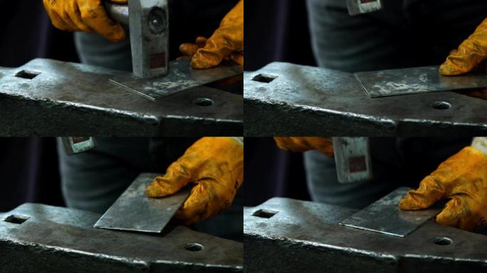 锤击金属特写升格慢动作铸造手套敲打铁片