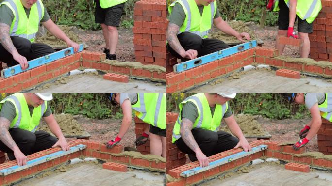 男女建筑工人用水泥砌砖