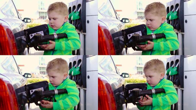 婴儿在加油站使用汽油泵