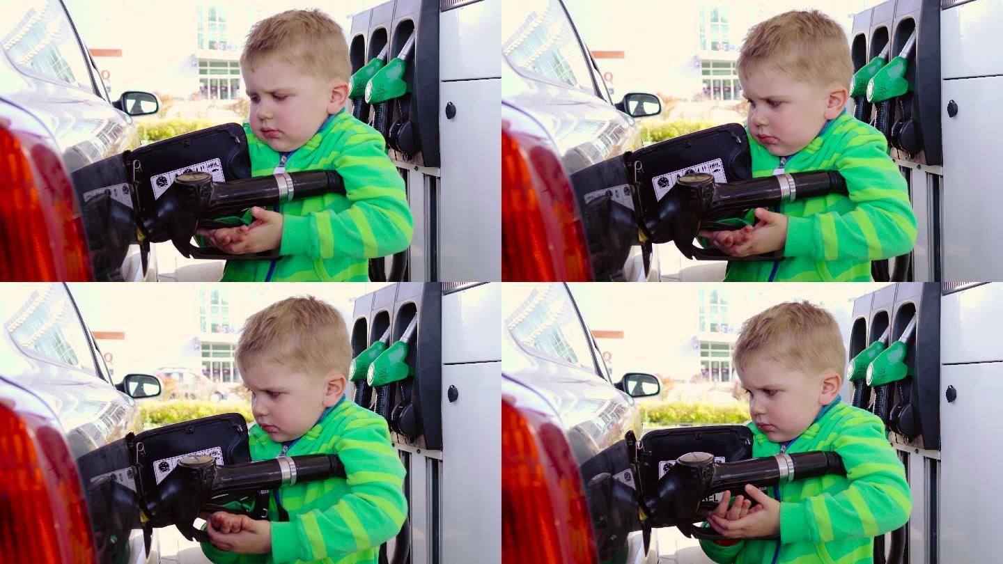 婴儿在加油站使用汽油泵