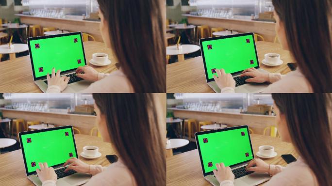一名女子使用绿色屏幕笔记本电脑