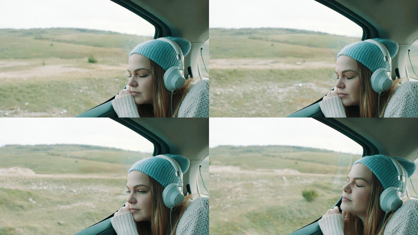 坐在汽车后座听音乐的微笑女孩