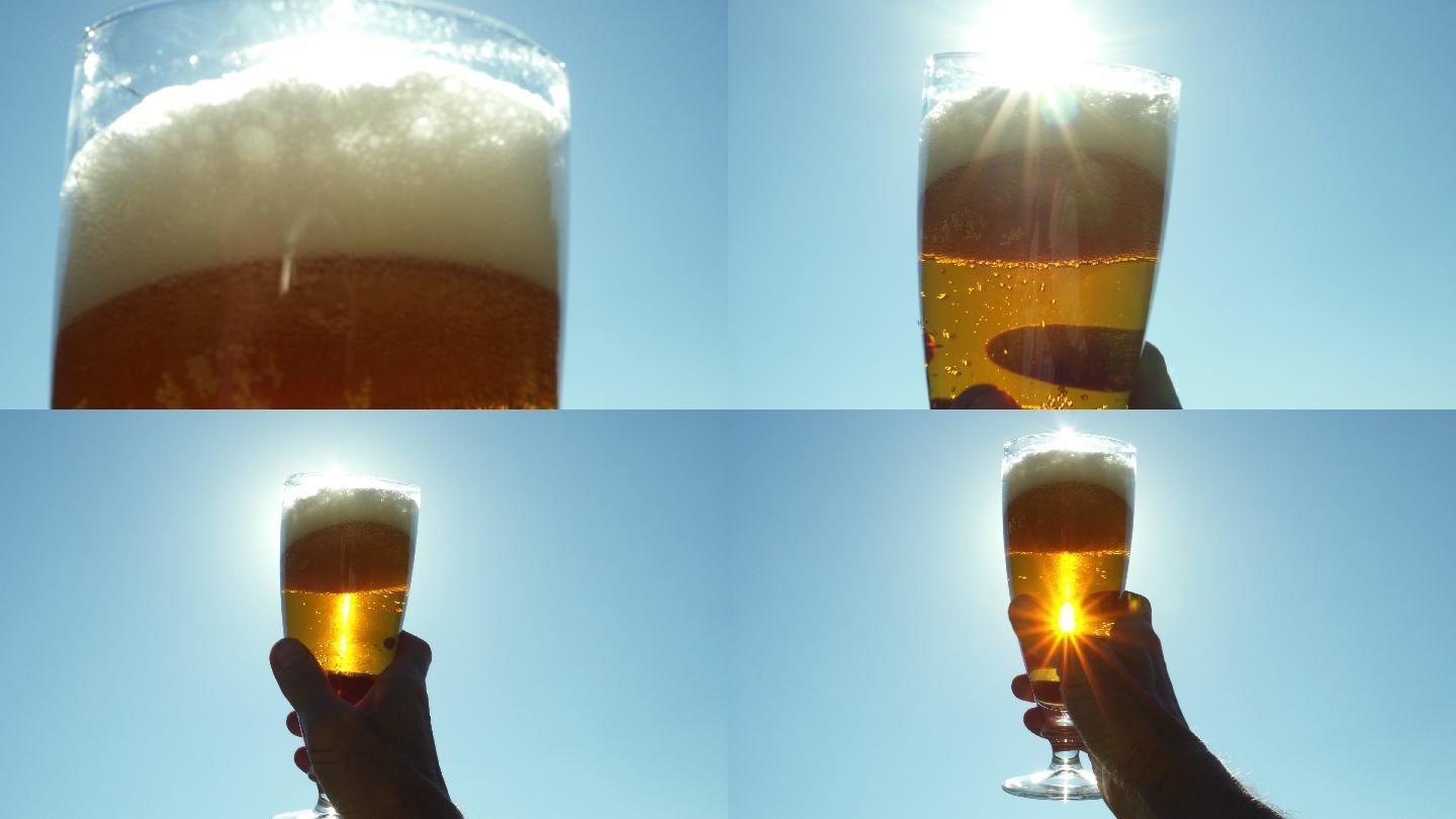 在阳光下手拿一杯啤酒