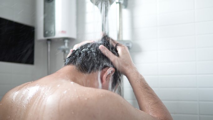 一名男子正在浴室洗头发和沐浴