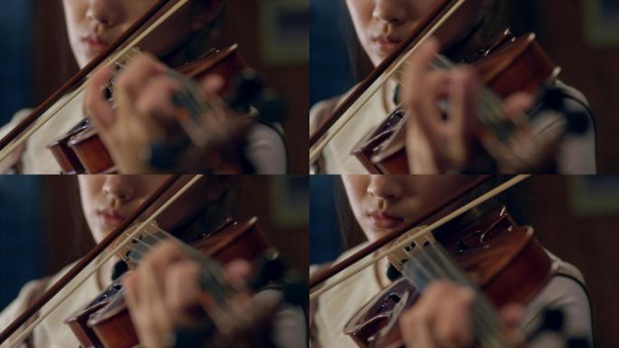 女孩夜晚在窗前拉小提琴