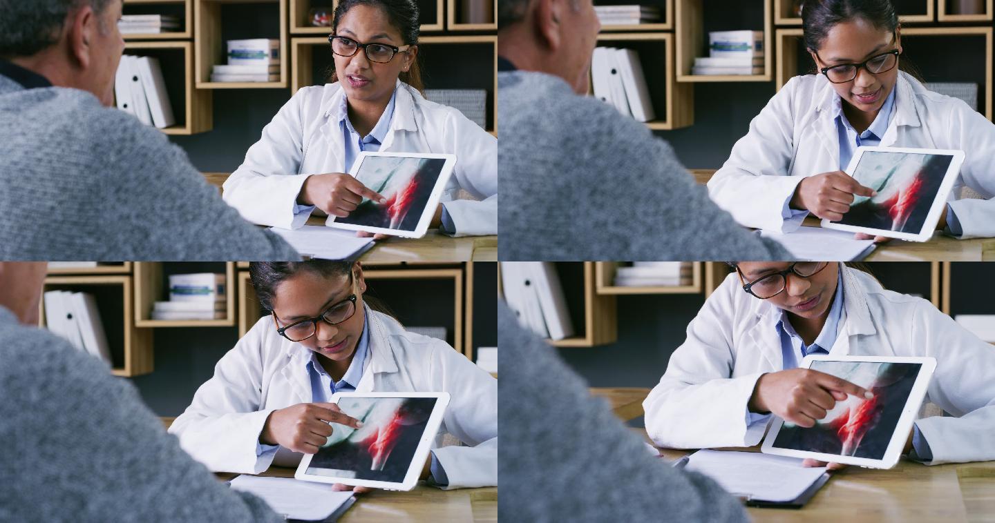 一名医生使用数字平板电脑与患者讨论髋关节