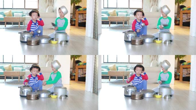两个兄弟在地板上玩锅碗瓢盆