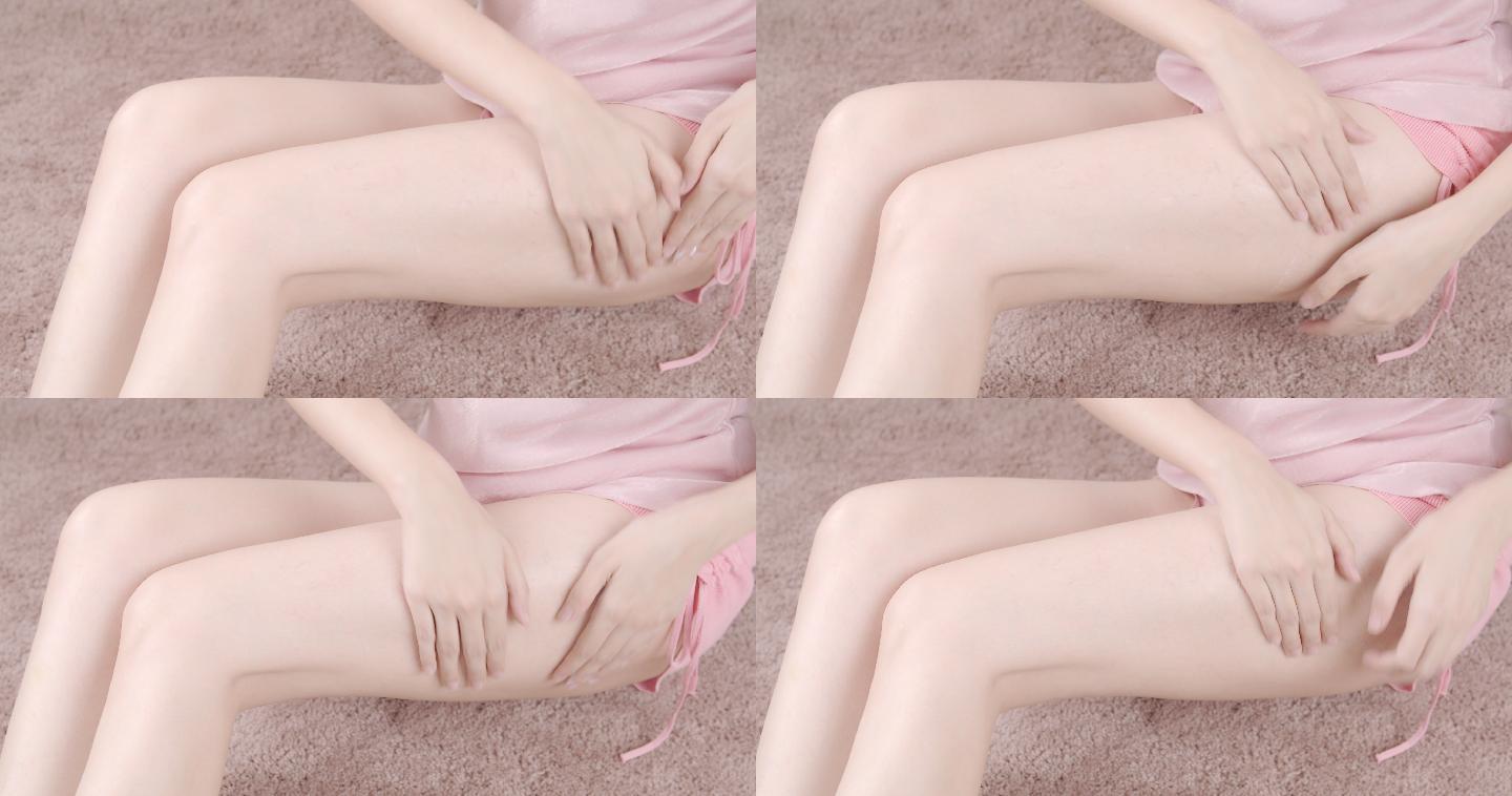 女孩在腿部涂身体乳。