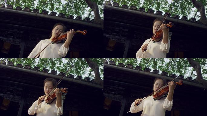 女孩在古老的院子里拉小提琴