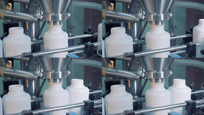 工业机器将药品放入塑料罐中