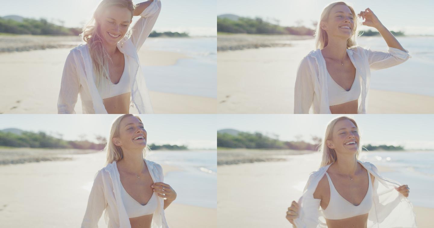 年轻的女人微笑着走在海滩上
