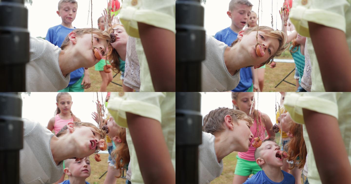 儿童玩派对吃甜甜圈游戏的特写镜头