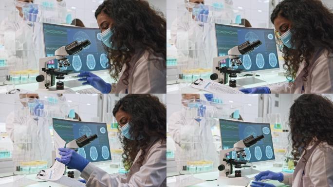女科学家使用显微镜