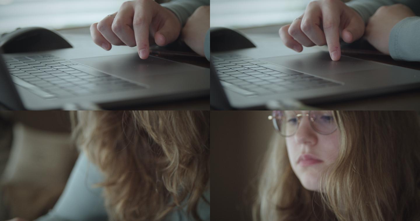 一个十几岁的女孩在家用笔记本电脑做功课。