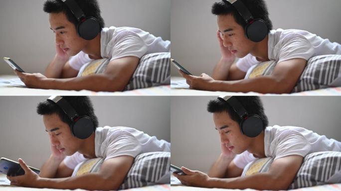 少年躺在床上用耳机听音乐