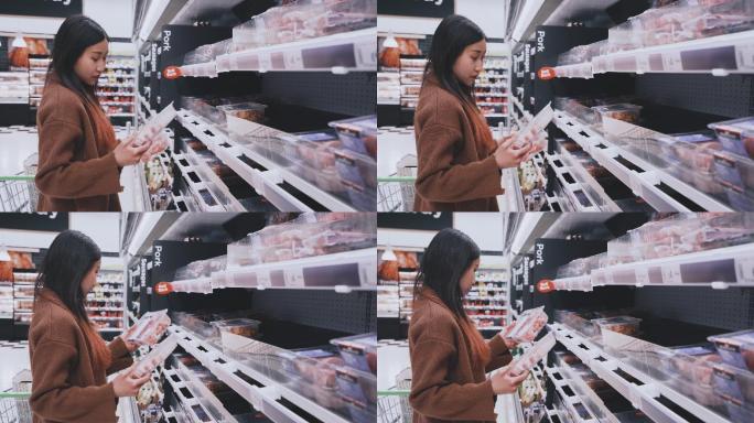 年轻女子选择在超市买肉