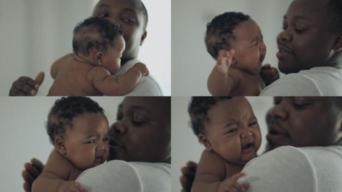 非洲裔美国父亲安慰哭泣的新生女儿