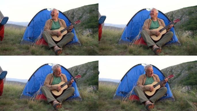宿营时坐在帐篷前弹吉他的老人