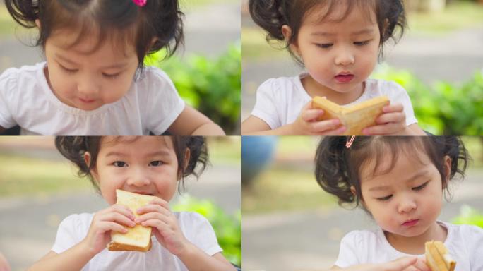 小女孩在吃黄油面包