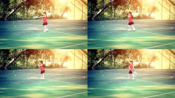 网球场上的小女孩打球接球高清素材