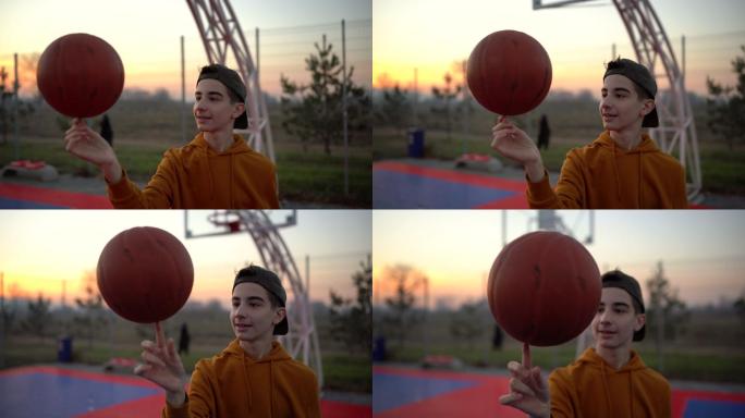 十几岁的男孩在运动场上旋转篮球
